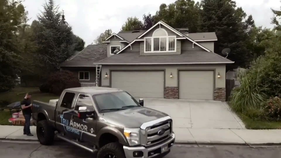 Tru Armor Roofing truck at a completed roof replacement, then an aerial view of the finished roof