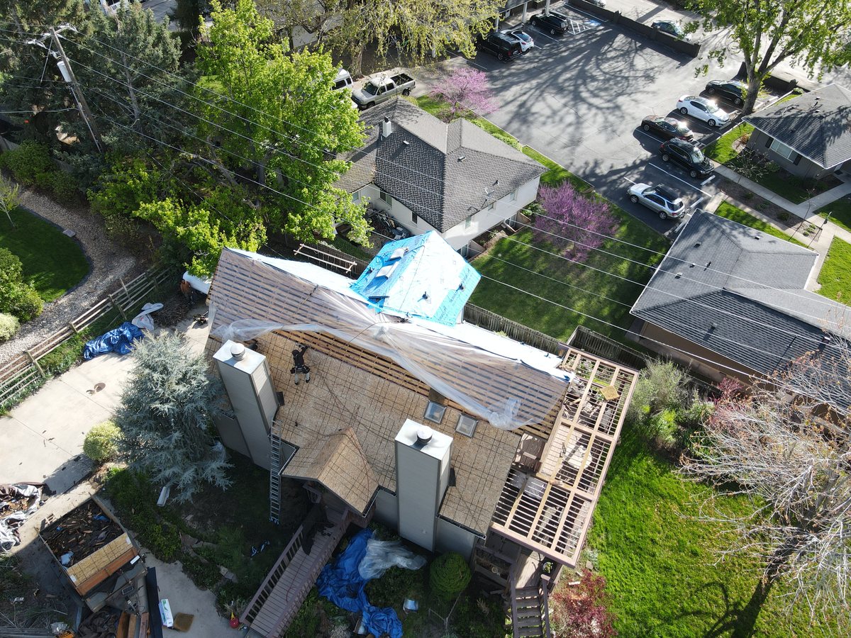 Roof stripped to the bare decking during inspection, showing the deck condition underneath