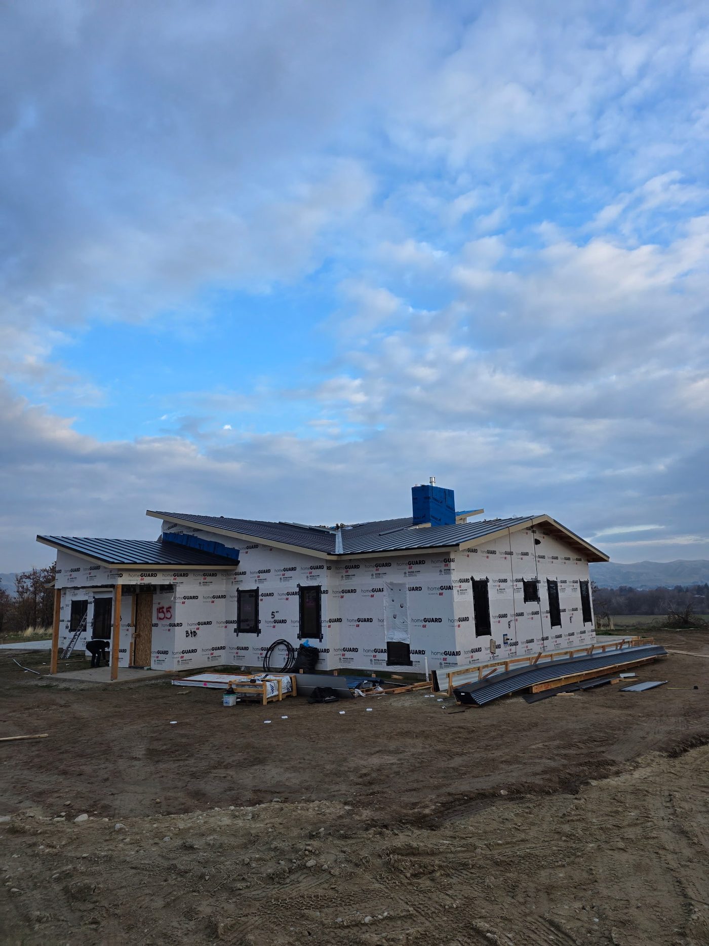 New construction home with completed standing seam metal roof