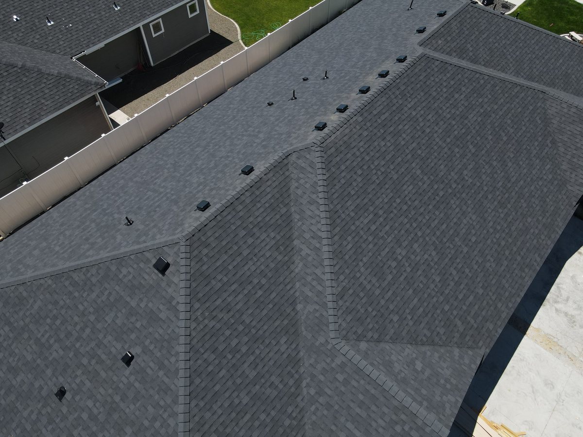 Close aerial view of ridge and hip shingle detail on a repaired roof
