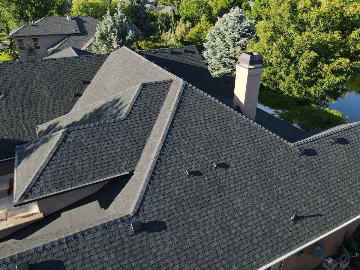 Architectural asphalt shingle roof with ridge and chimney flashing detail