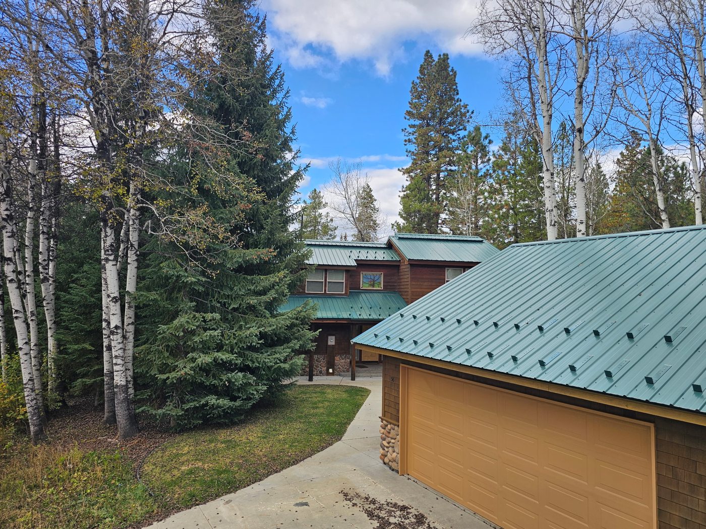 Green Tuff Rib metal roof in McCall with custom snow clip retention system installed