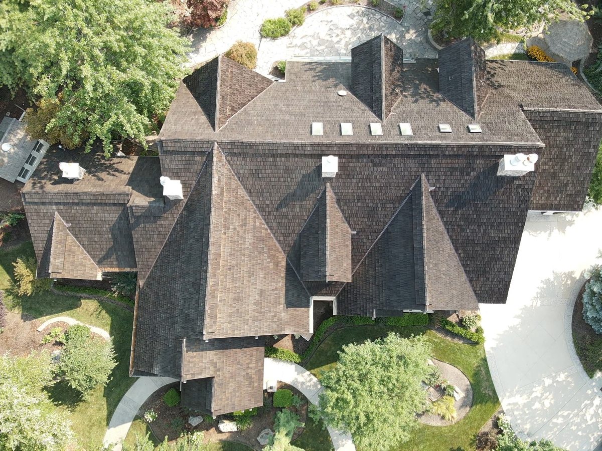 Aerial view of the cedar shake estate roof, full layout with skylights