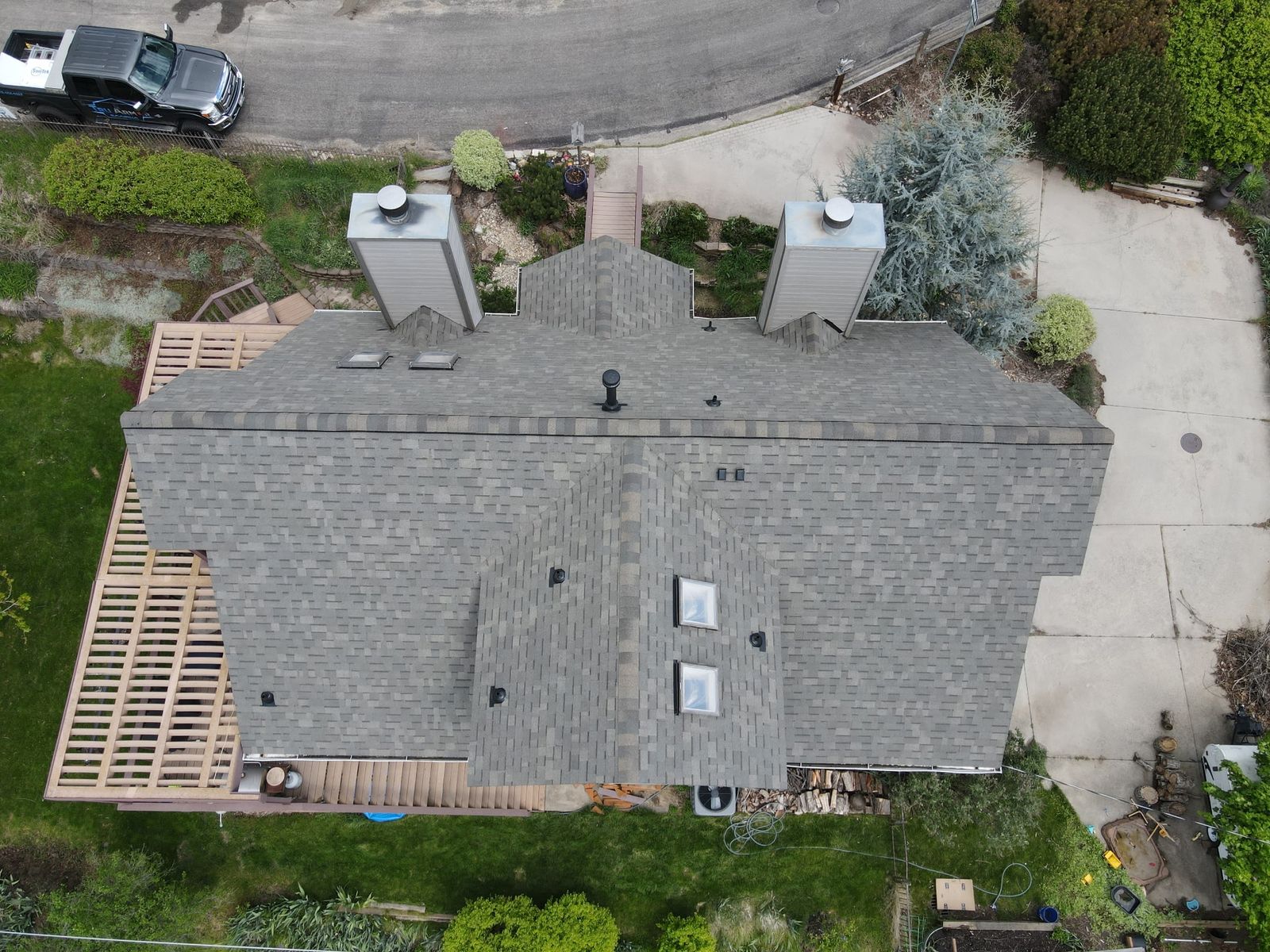 Tru Armor Roofing truck at a completed roof replacement