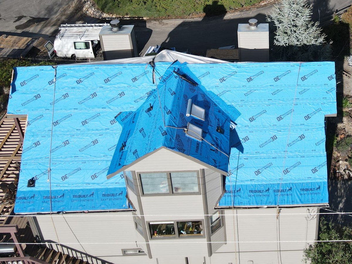 Home fully wrapped in synthetic underlayment mid roof replacement, Boise foothills
