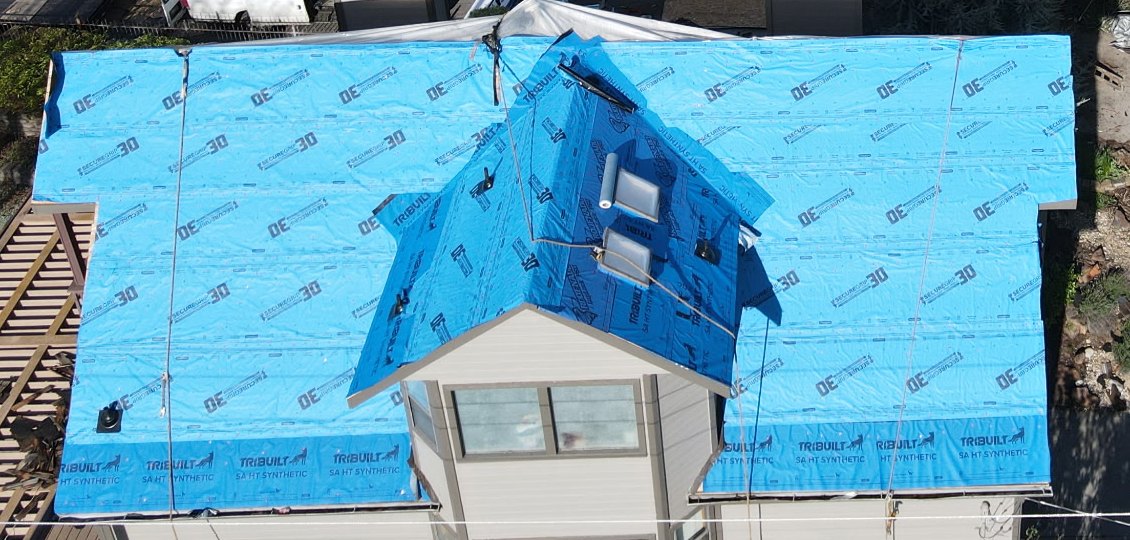 Full roof replacement in progress - deck protected with synthetic underlayment before new shingles