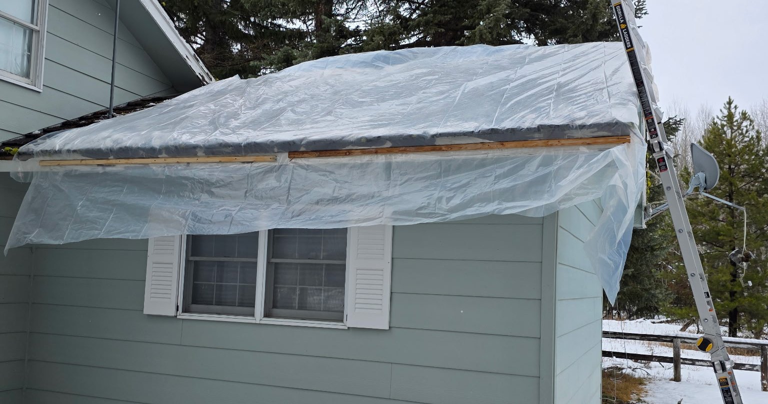 Storm-damaged roof tarped and sealed by Tru Armor to stop water intrusion