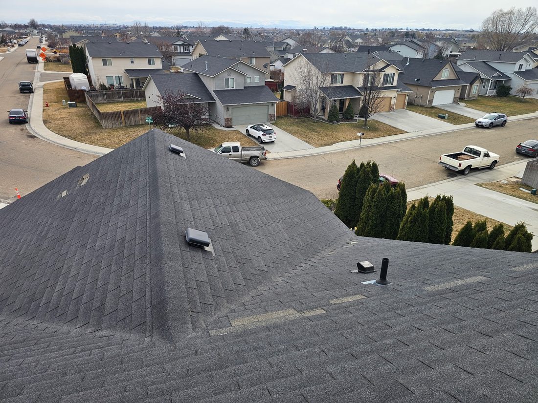 Wind claim: aerial view of wind-damaged shingle roof in a Treasure Valley neighborhood